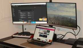 A MacBook Air powering external monitors with the StarTech adapter.