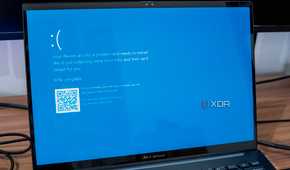 A Windows 11 laptop showing a Blue Screen of Death