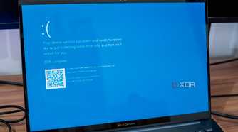 A Windows 11 laptop showing a Blue Screen of Death