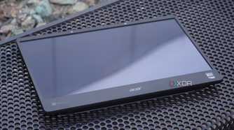 The SpatialLabs monitor lying on a metal bench.