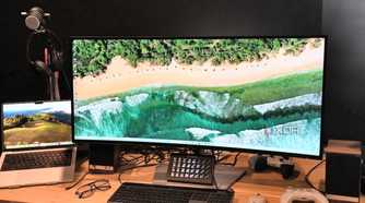 Dell UltraSharp 40 Curved Thunderbolt Hub Monitor with MacBook Pro, eyeglasses, Legato Stream Deck, white wireless mouse and white Xbox controller
