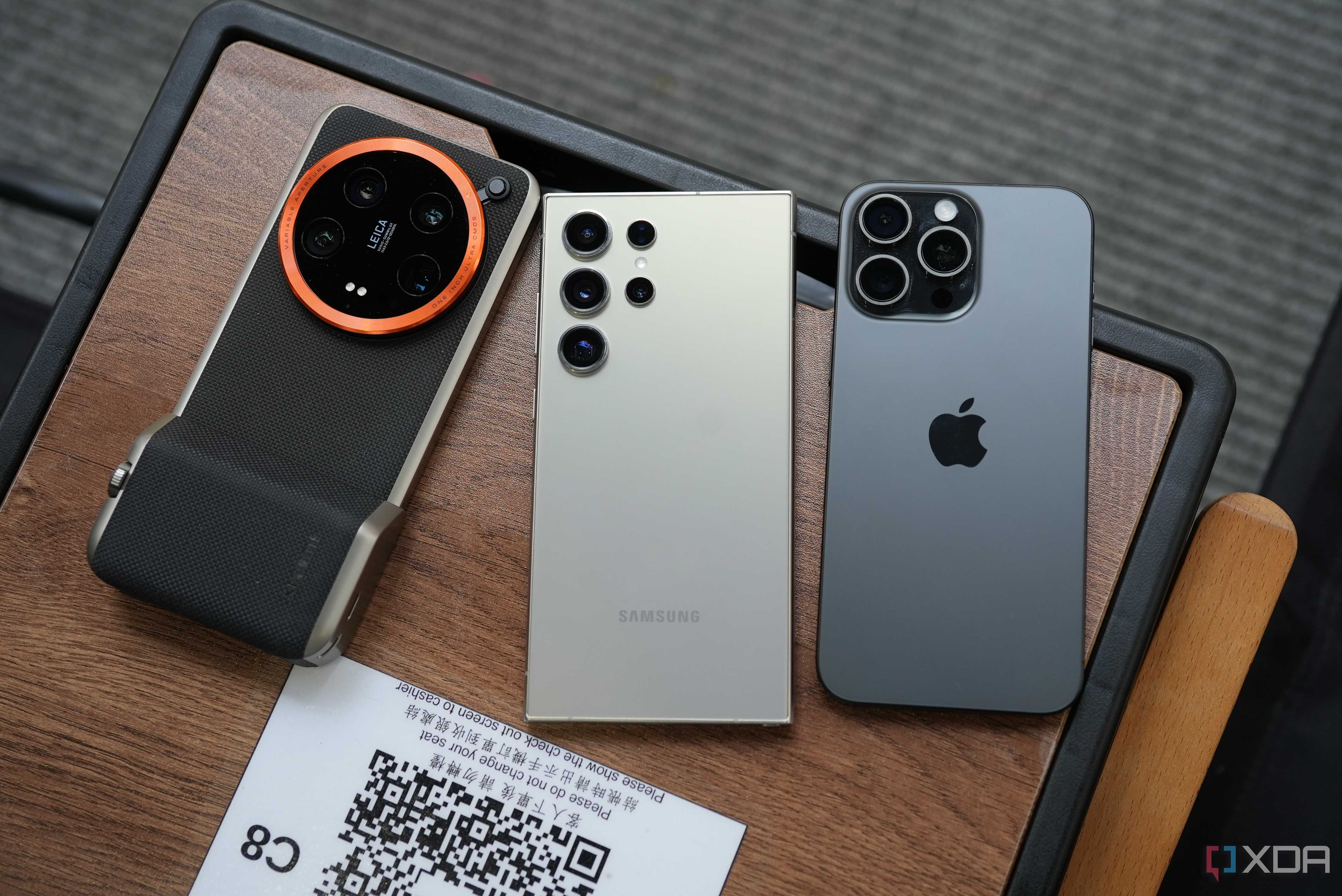 xiaomi 14 ultra, s24 ultra and iphone 15 pro max side by side on a table