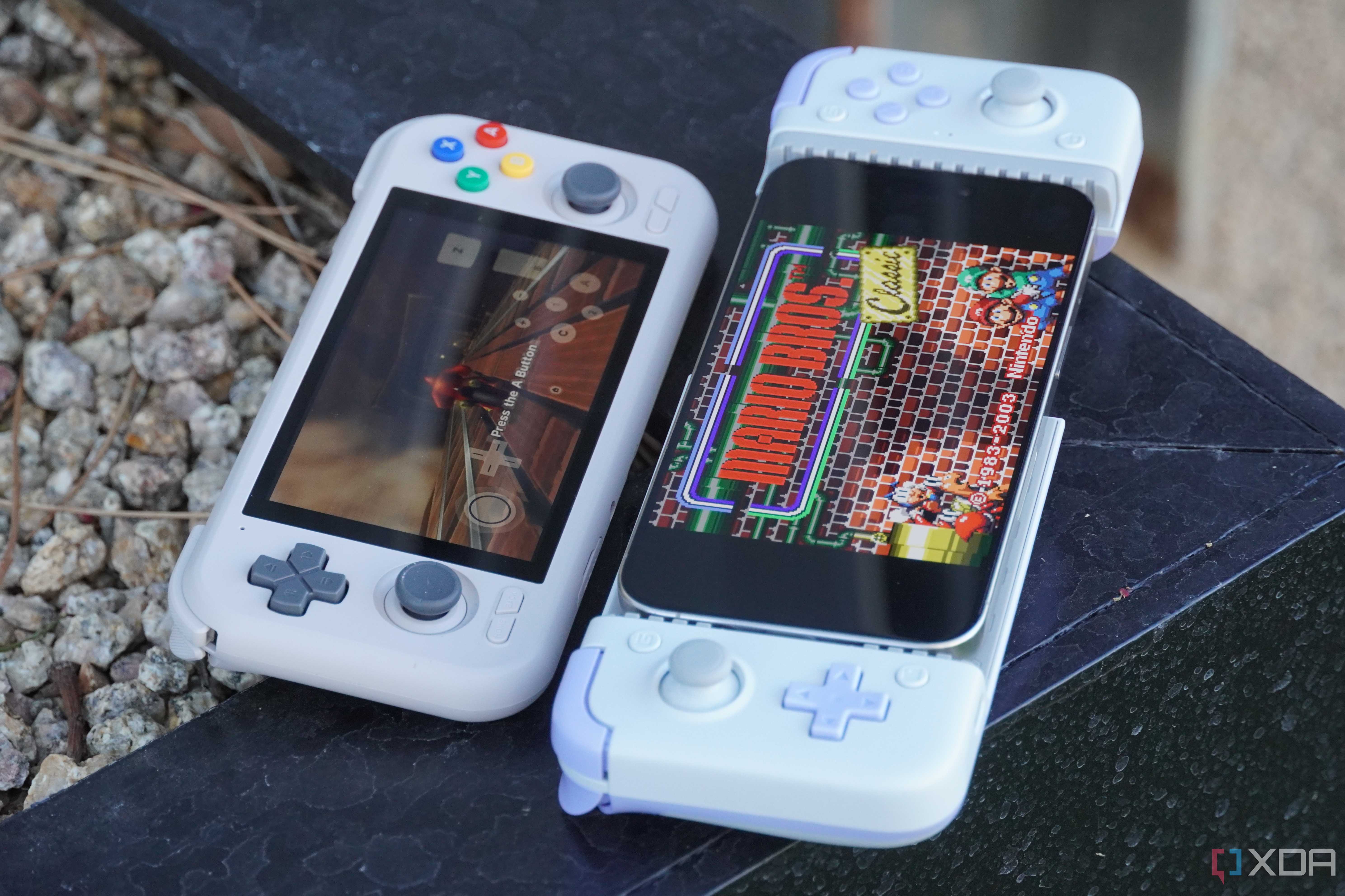 An iPhone next to an Android gaming handheld.