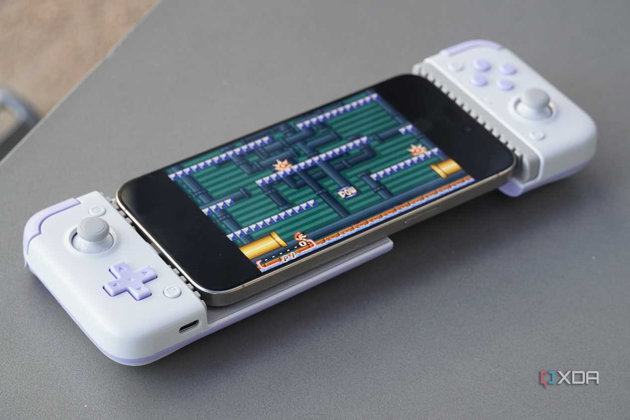 An iPhone connected to a mobile gaming controller.