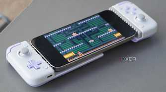 An iPhone connected to a mobile gaming controller.