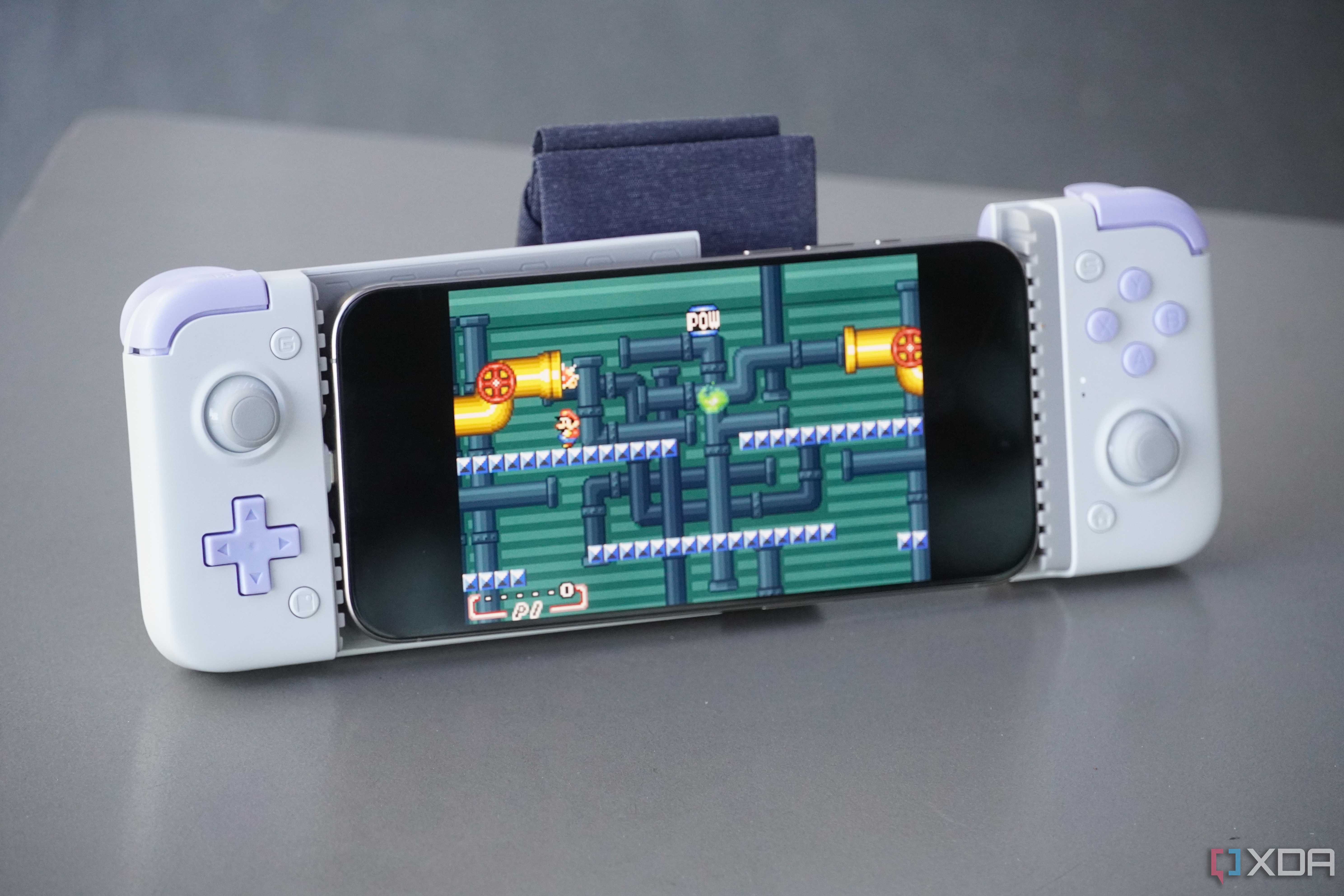 An iPhone connected to a bulky external game controller.