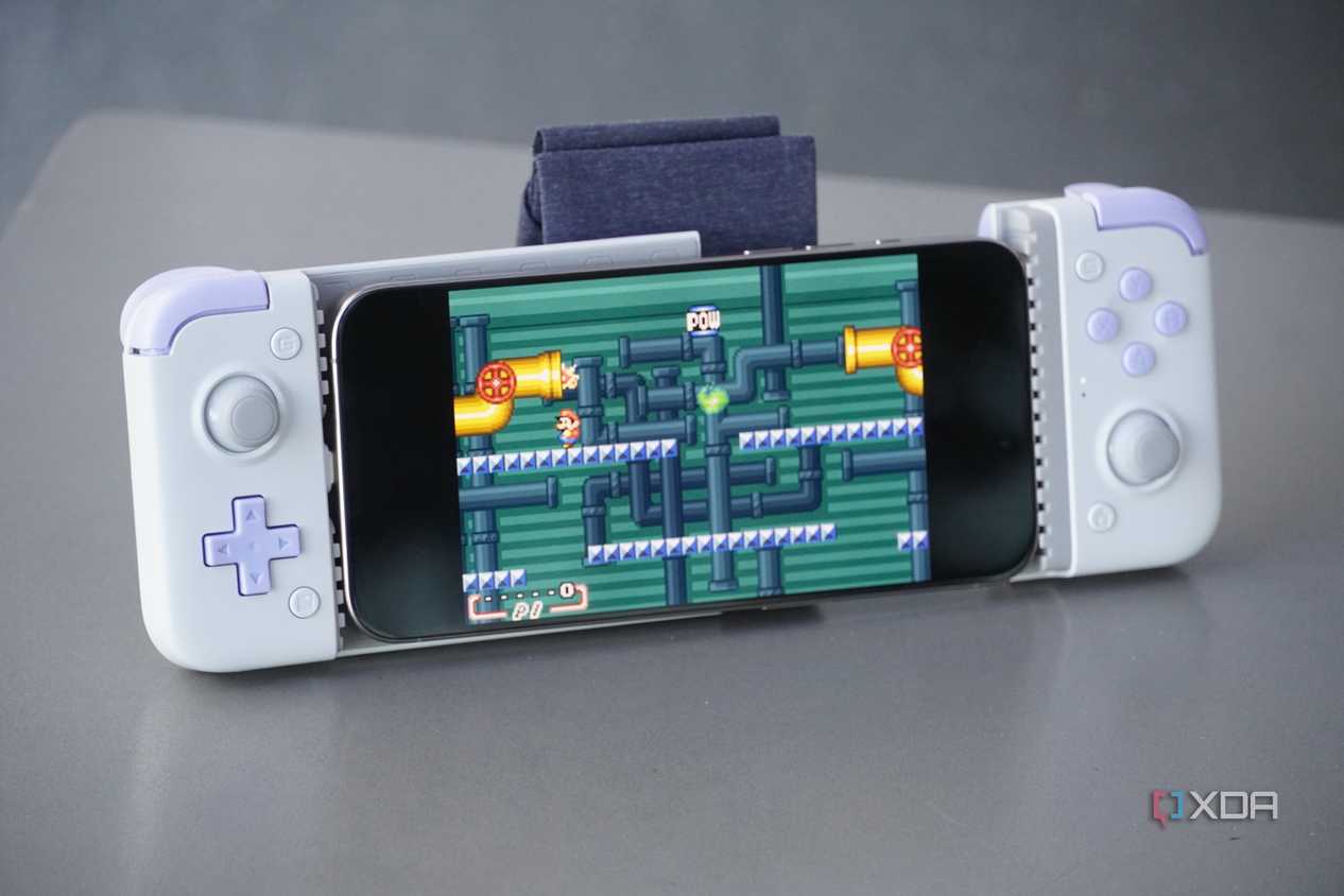 An iPhone connected to a bulky external game controller.
