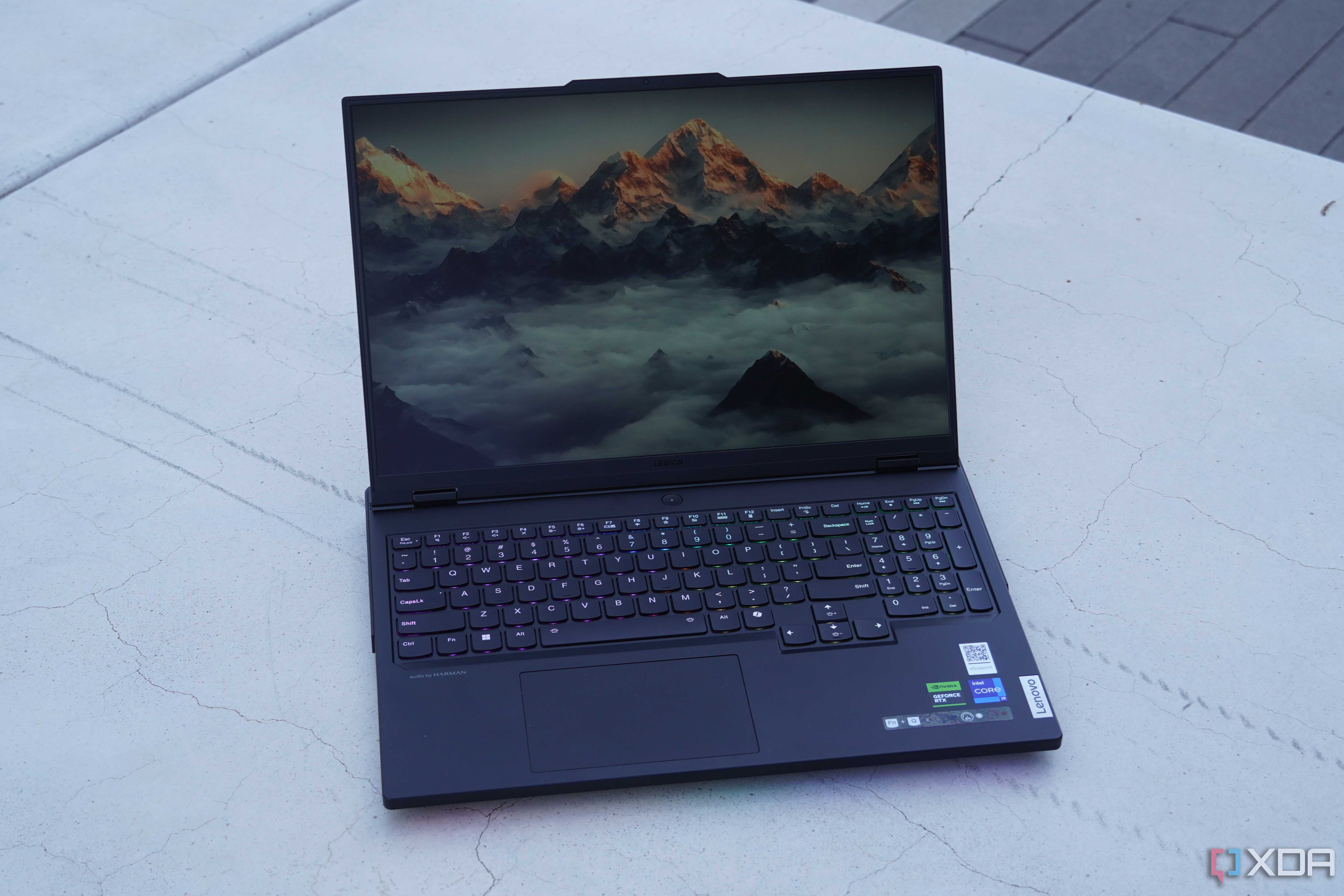 The Lenovo Legion Pro 7i on a concrete bench.