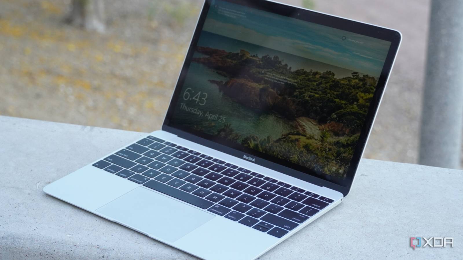 A side view of the Windows 10 Lock Screen on a MacBook.