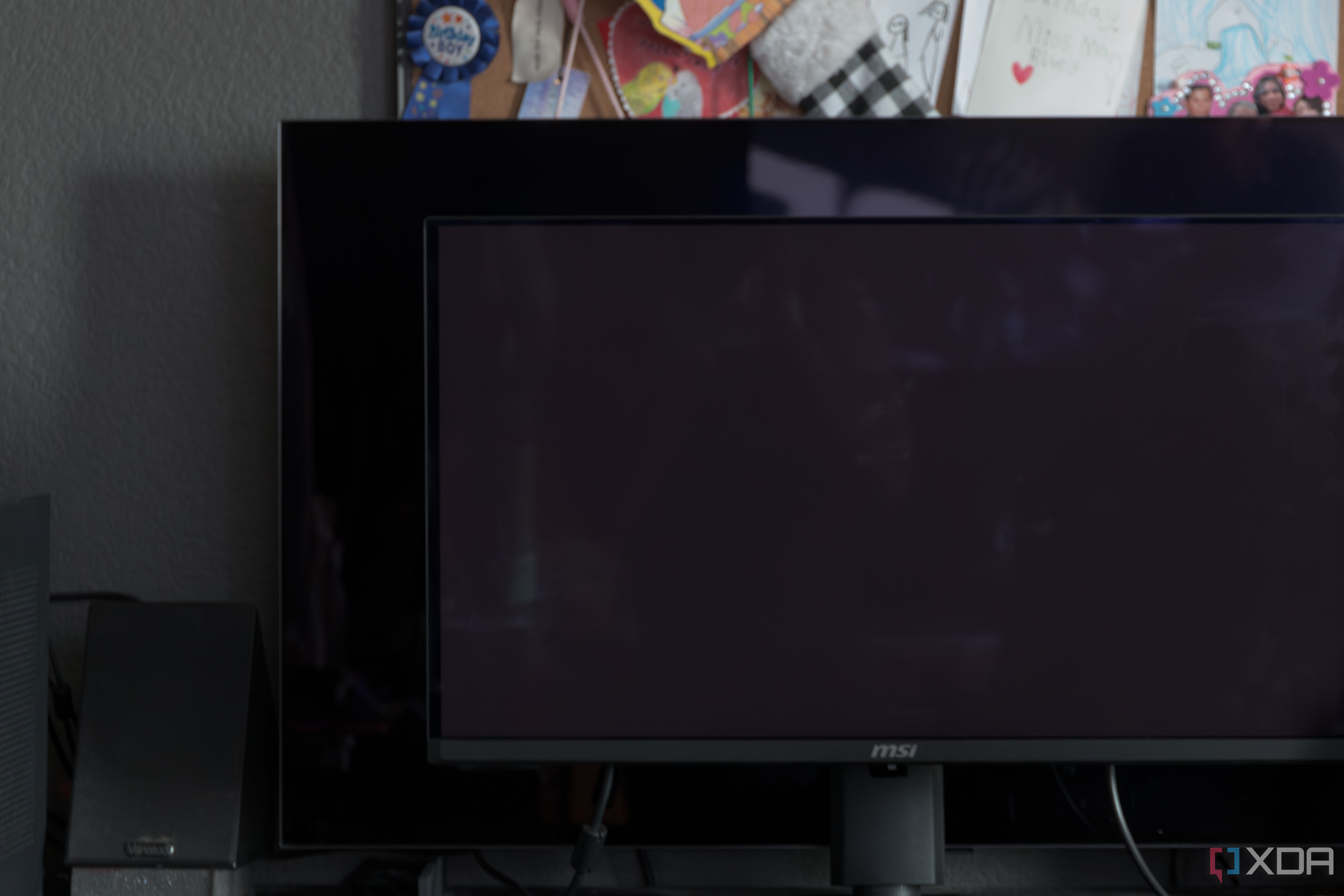 The MSI MAG 271QPX next to the LG C2 showing the difference in black levels