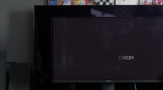 The MSI MAG 271QPX next to the LG C2 showing the difference in black levels