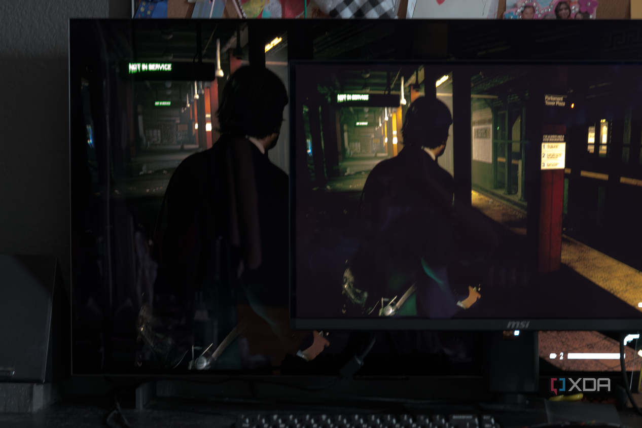 The MSI MAG 271QPX next to the LG C2 showing the difference in black levels in a game