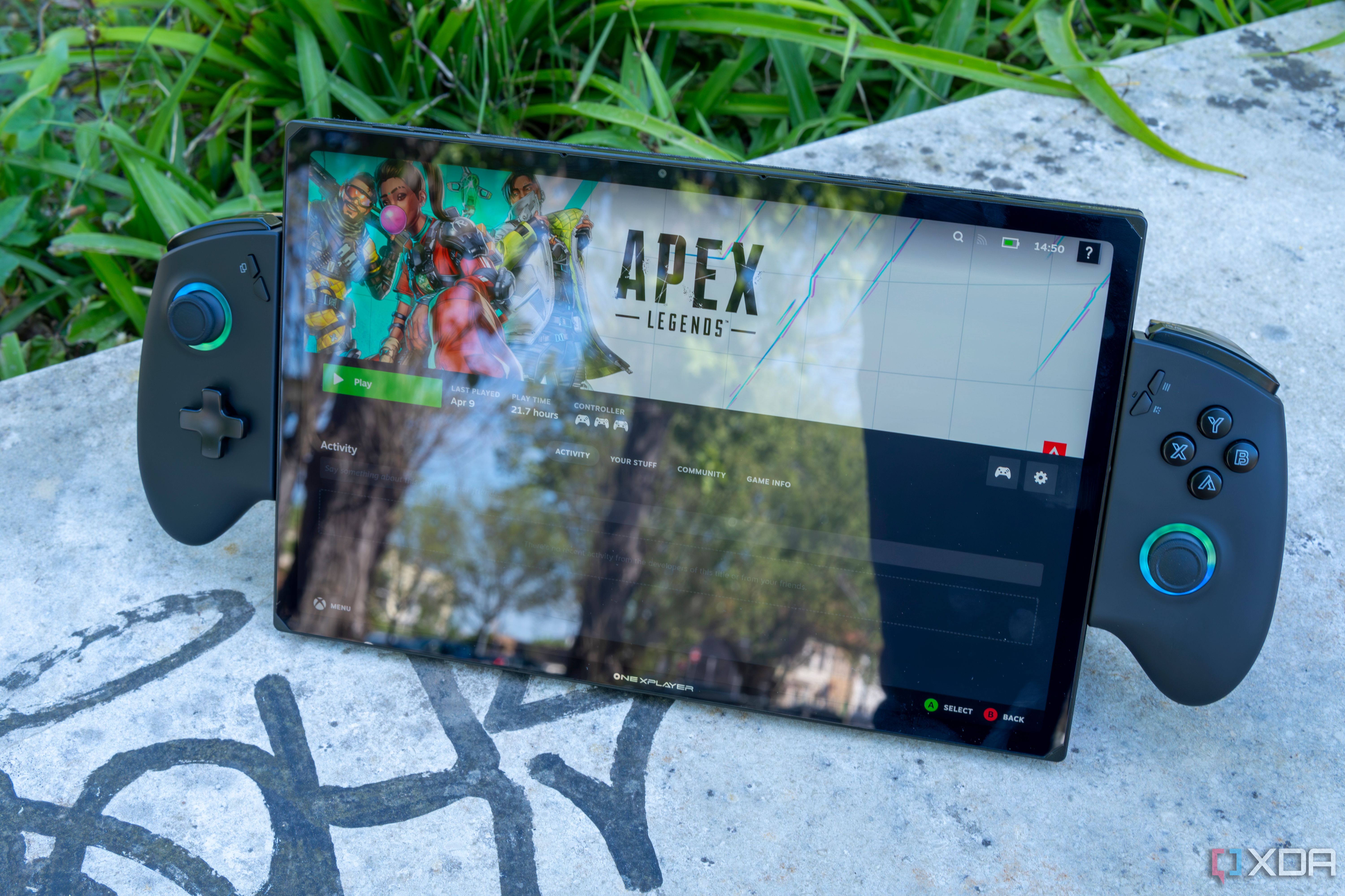 A One XPlayer X1 with controllers attached standing up on a stone slab