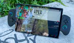 A One XPlayer X1 with controllers attached standing up on a stone slab