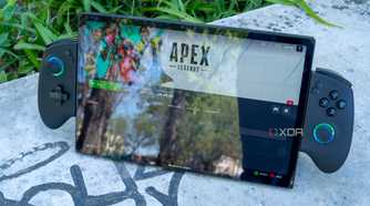 A One XPlayer X1 with controllers attached standing up on a stone slab