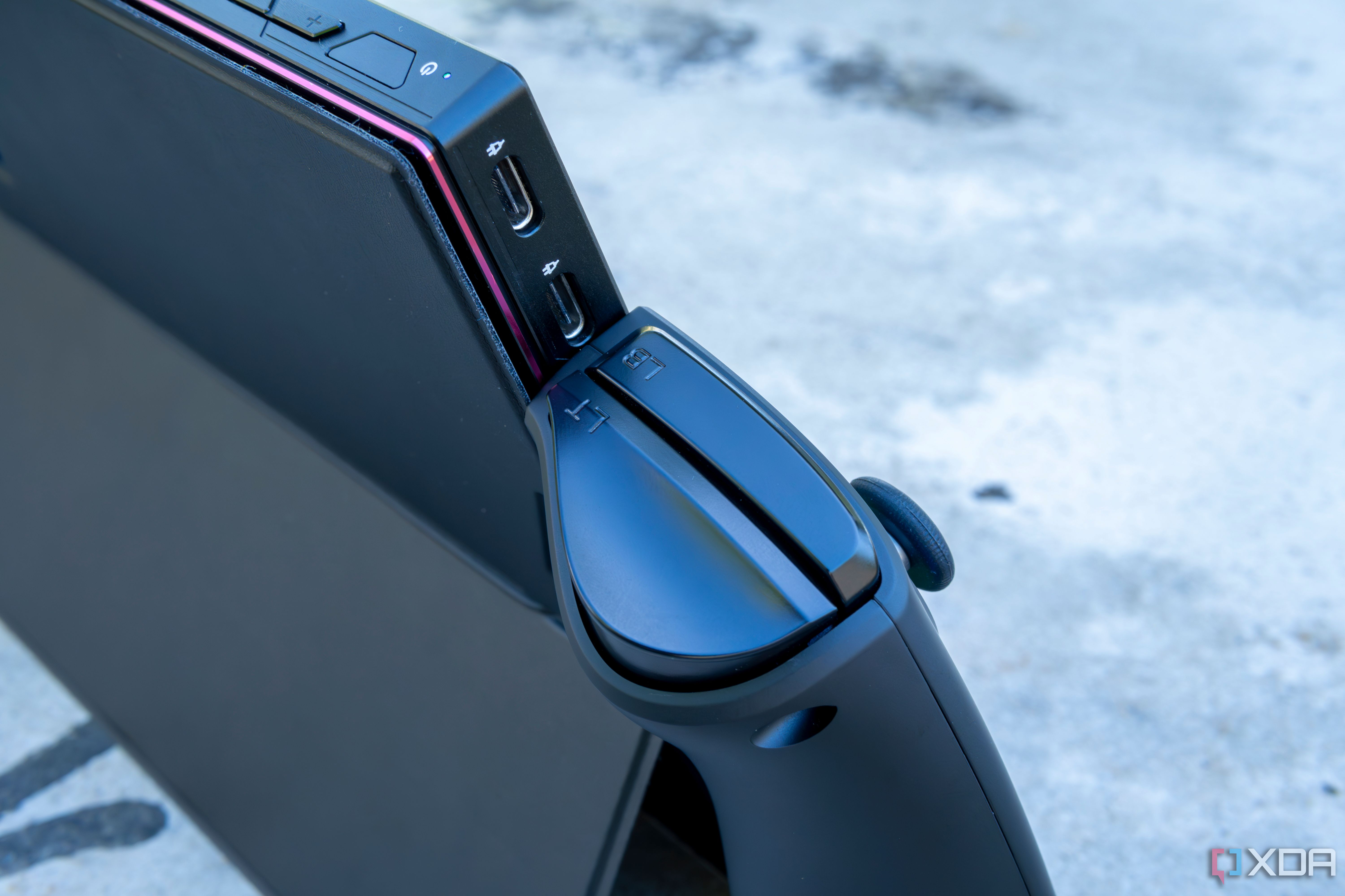 Close-up of the two USB Type-C ports on the One XPlayer with the controllers attached