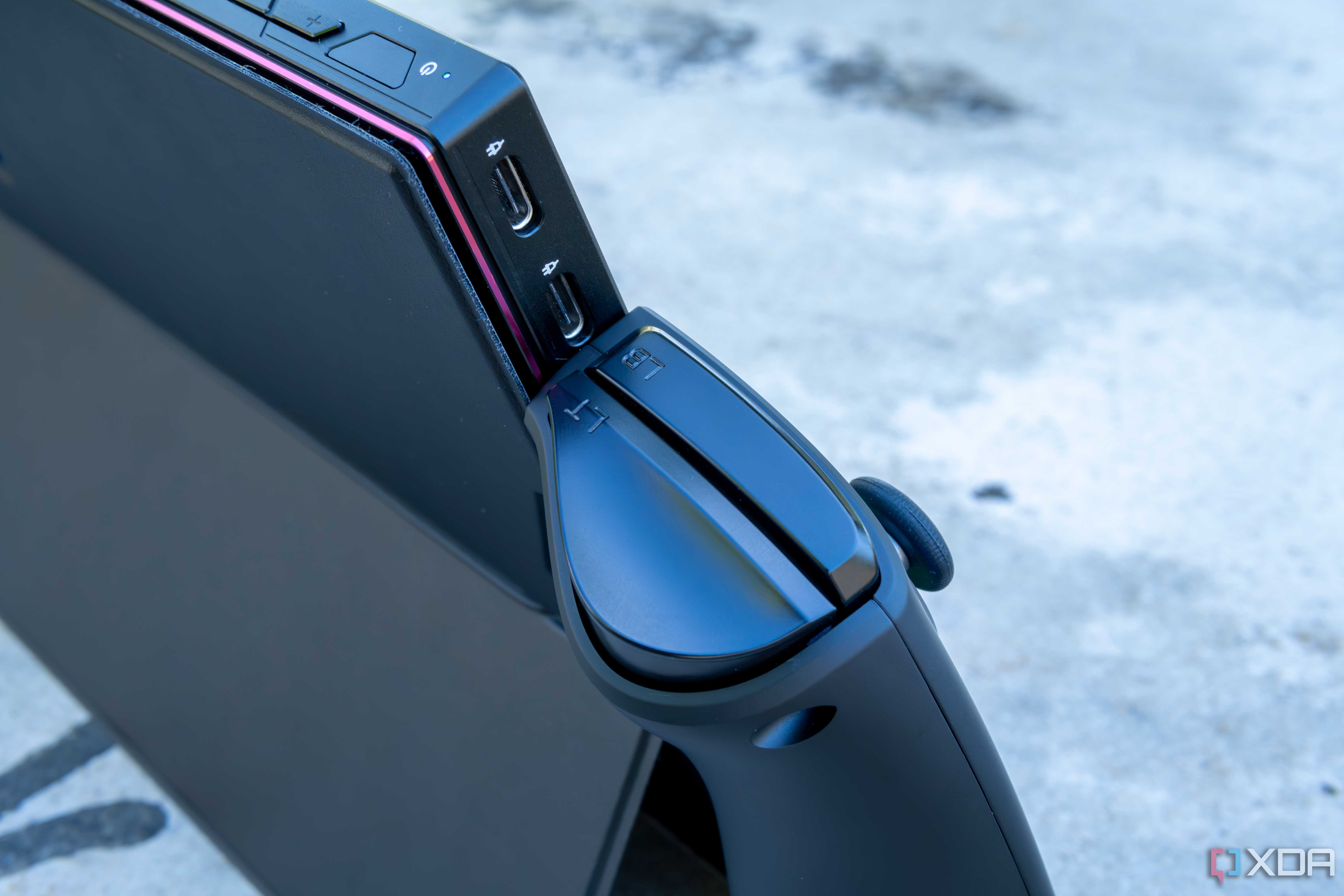 Close-up of the two USB Type-C ports on the One XPlayer with the controllers attached