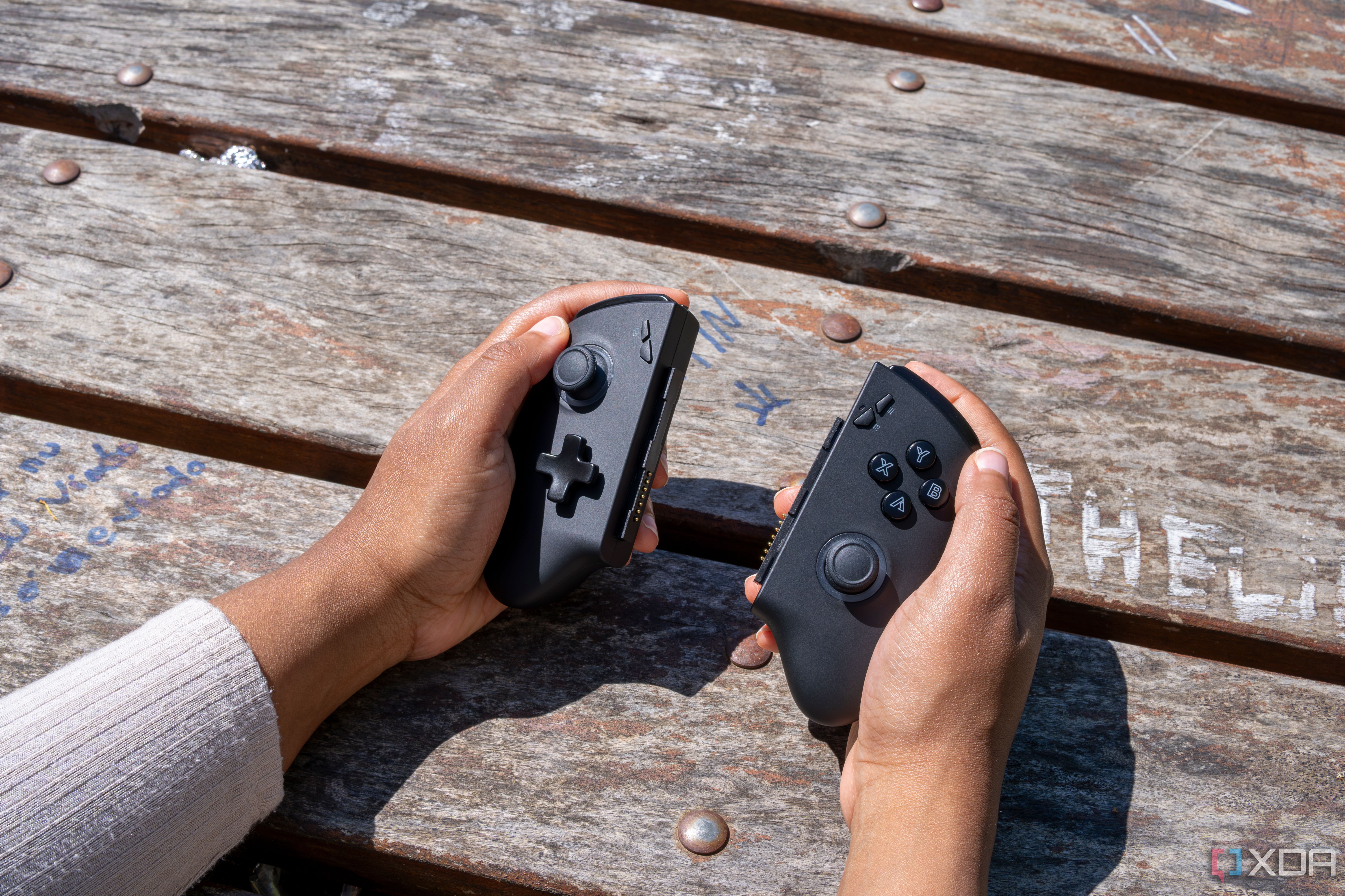 The One XPlayer X1 controllers held in someone's hands
