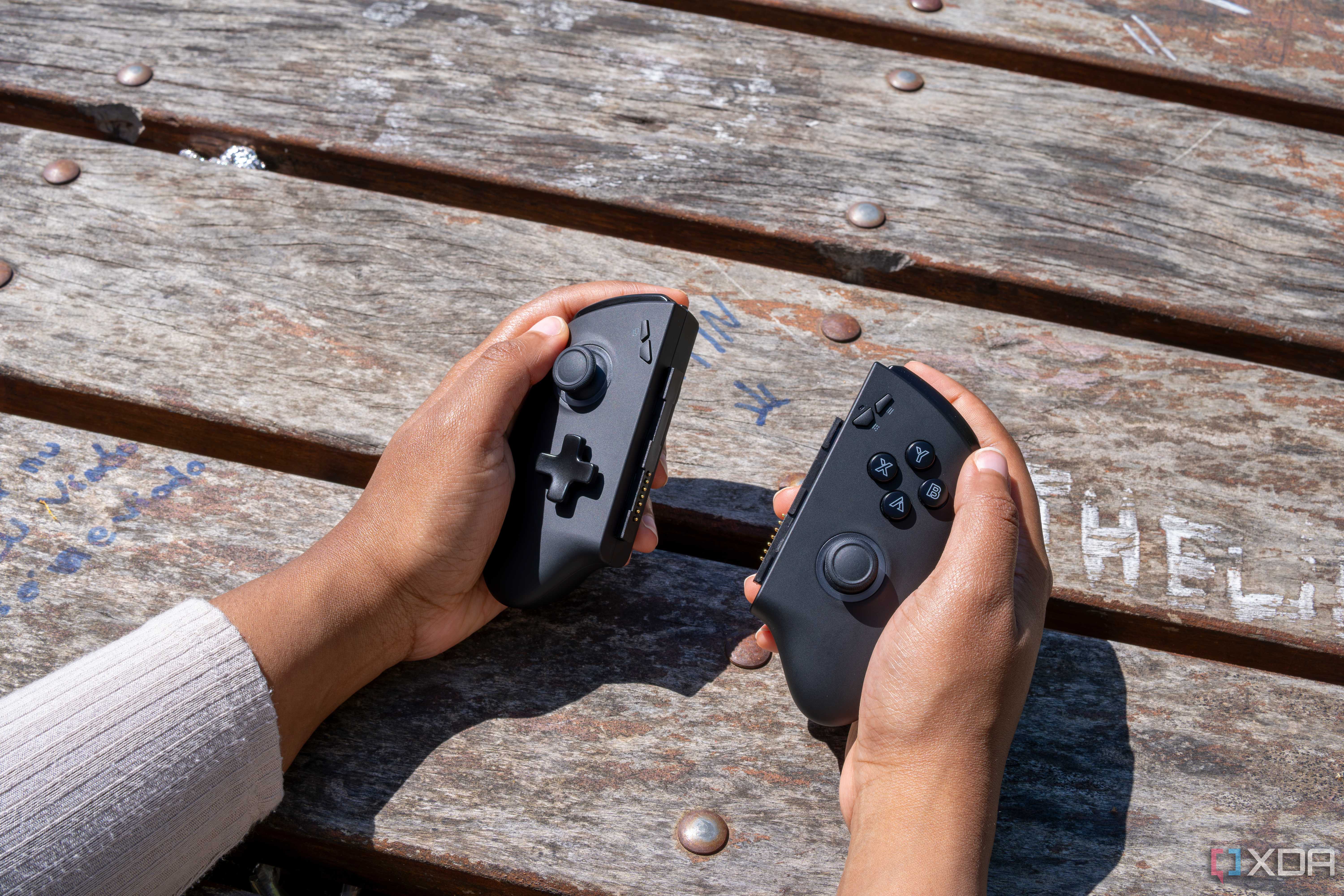 The One XPlayer X1 controllers held in someone's hands