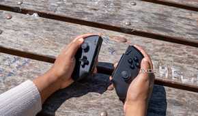 The One XPlayer X1 controllers held in someone's hands