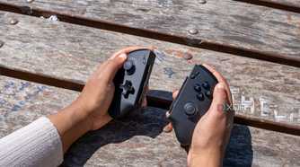 The One XPlayer X1 controllers held in someone's hands