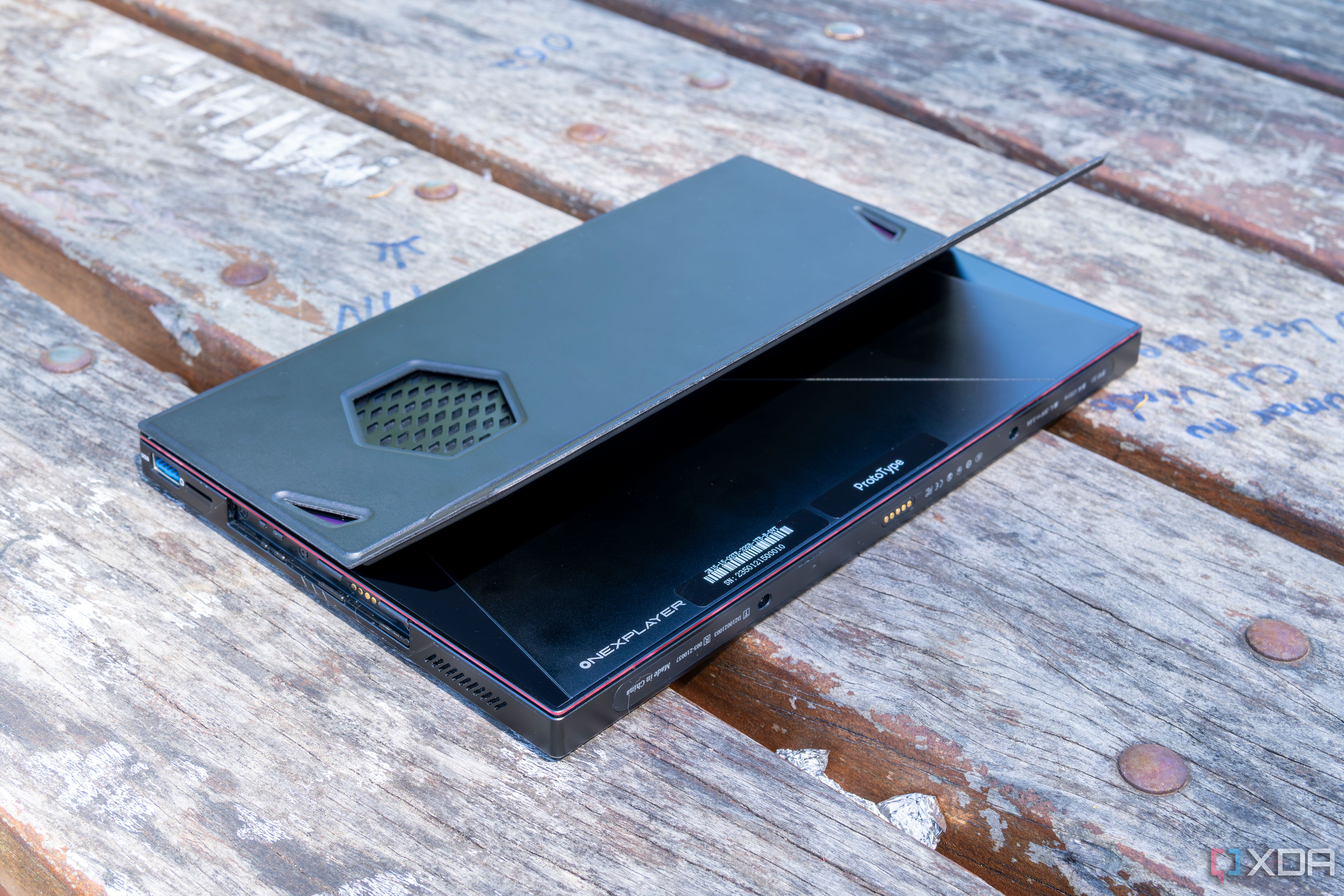 A One Xplayer X1 face down on a wooden table with the kickstand open