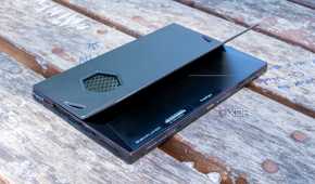 A One Xplayer X1 face down on a wooden table with the kickstand open
