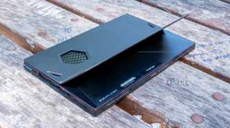 A One Xplayer X1 face down on a wooden table with the kickstand open