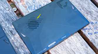 A One XPlayer face down on a wooden table with the back plate removed