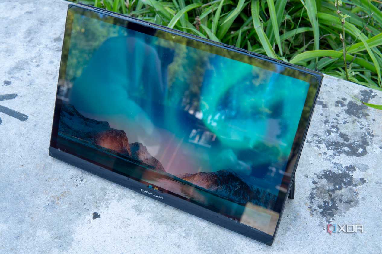 Angled front view of the One XPlayer X1 showing the Windows 11 desktop with controllers detached
