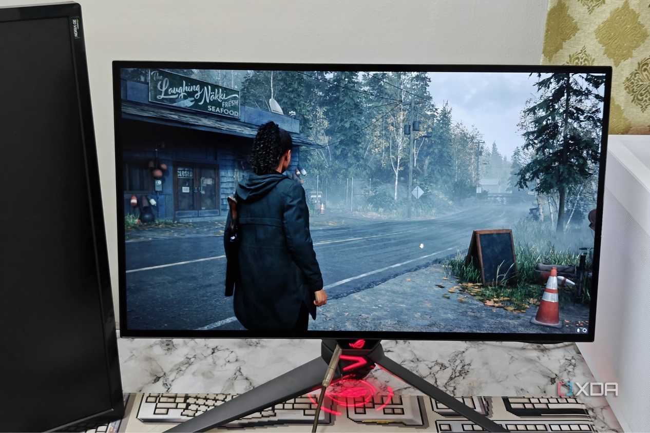 An image showing the Asus ROG PG27AQDM monitor displaying a screenshot from Alan Wake 2.