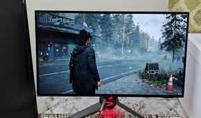 An image showing the Asus ROG PG27AQDM monitor displaying a screenshot from Alan Wake 2.