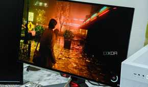 An image showing the Asus ROG PG27AQDM monitor displaying a screenshot from Alan Wake 2 game.