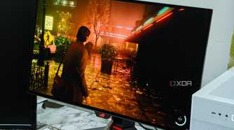An image showing the Asus ROG PG27AQDM monitor displaying a screenshot from Alan Wake 2 game.