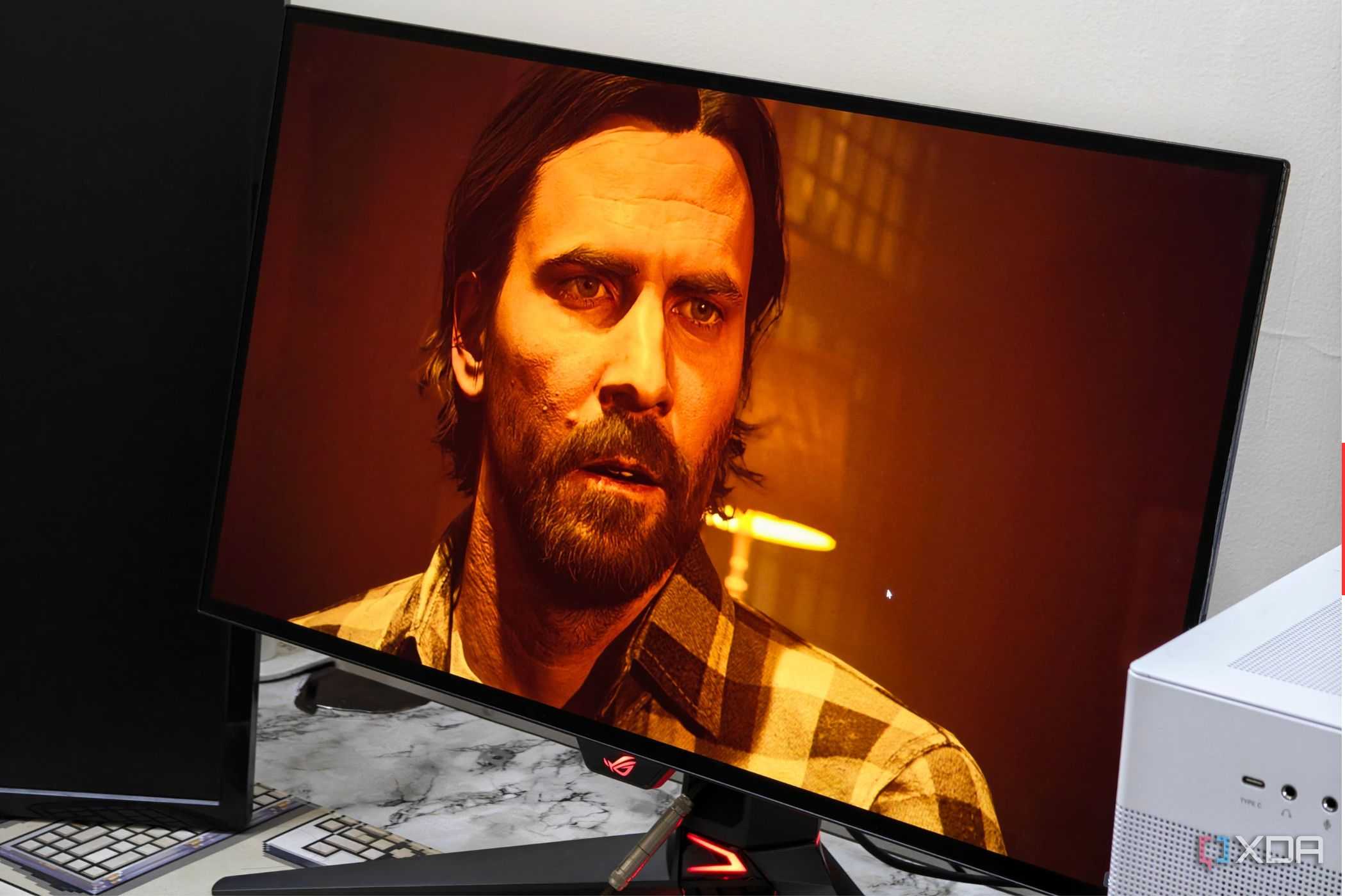 An image showing the Asus ROG Swift PG27AQDM monitor displaying a screenshot from Alan Wake 2 game.