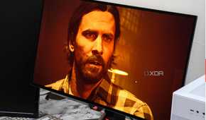 An image showing the Asus ROG Swift PG27AQDM monitor displaying a screenshot from Alan Wake 2 game.