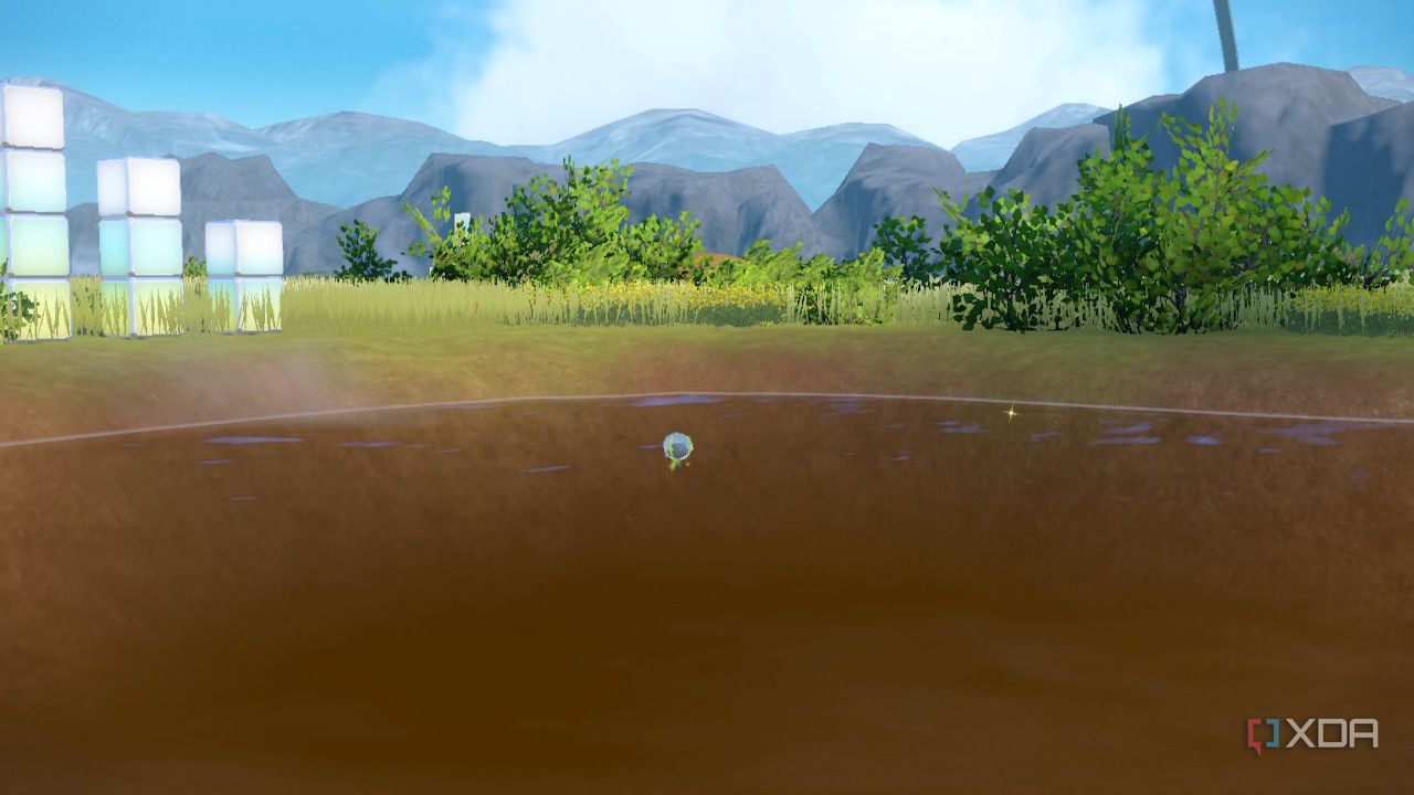 Screenshot of Pokémon Violet showing a pond with bushes nearby and mountains in the background