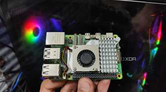A Raspberry Pi 5 held in front of a PC