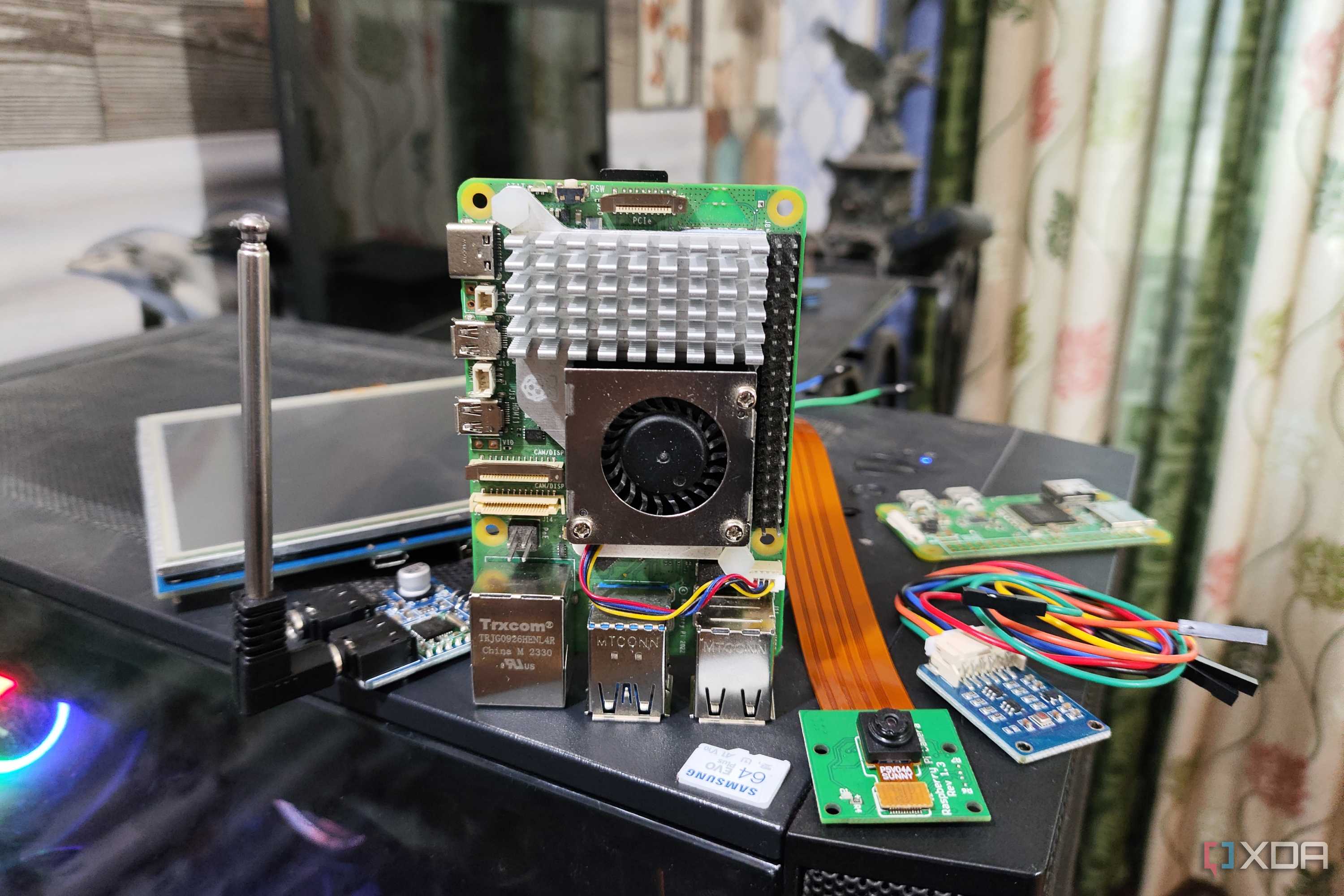 The Raspberry Pi 5 and its accessories lying on top of a PC