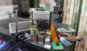The Raspberry Pi 5 and its accessories lying on top of a PC