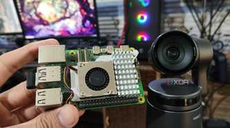 A Raspberry Pi 5 kept near an Obsbot Tail Air webcam, with a PC in the background