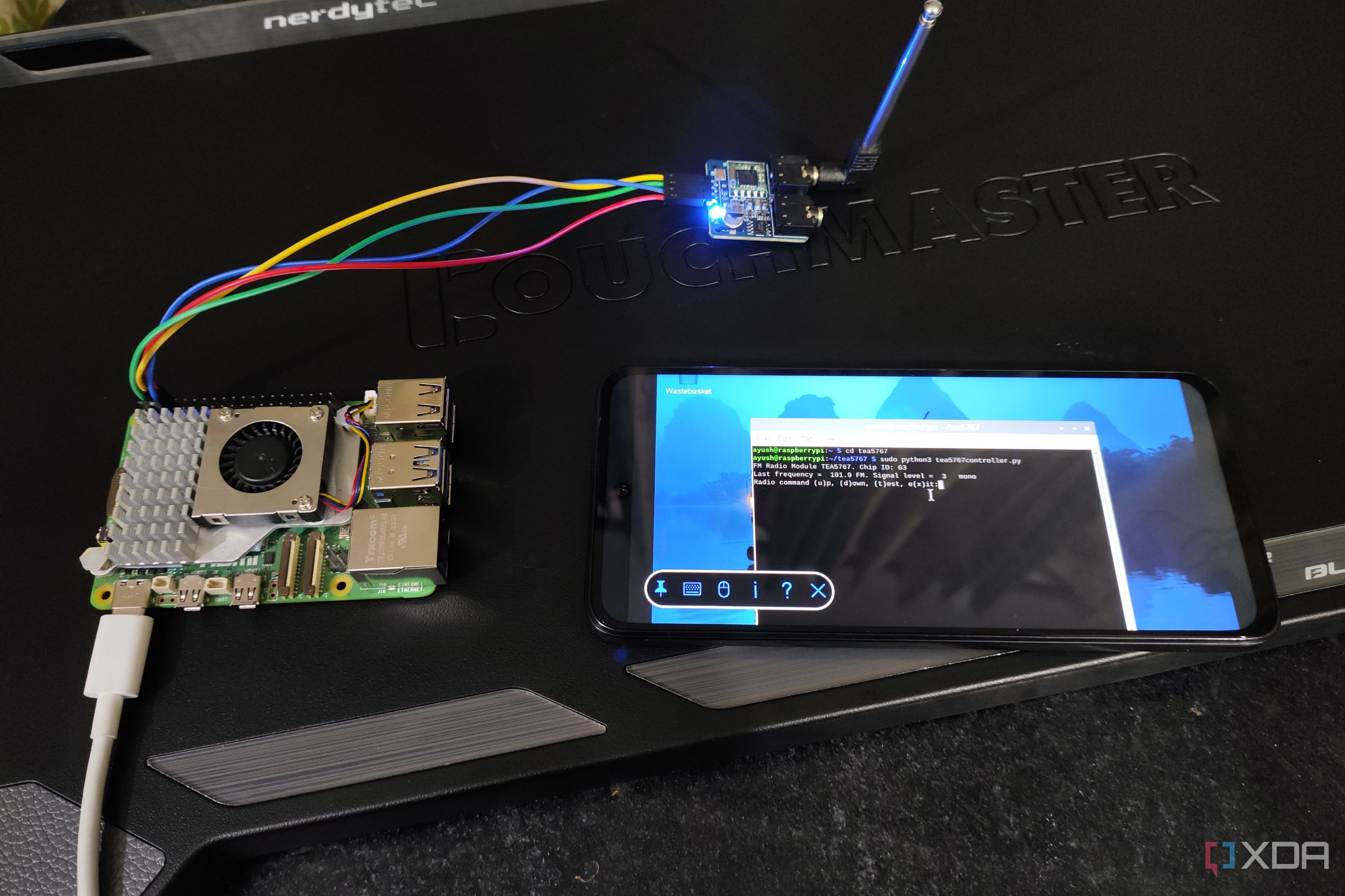 A Raspberry Pi 5 connected to a TEA5767 radio module and a Poco M6 Pro running the FM radio inside the terminal
