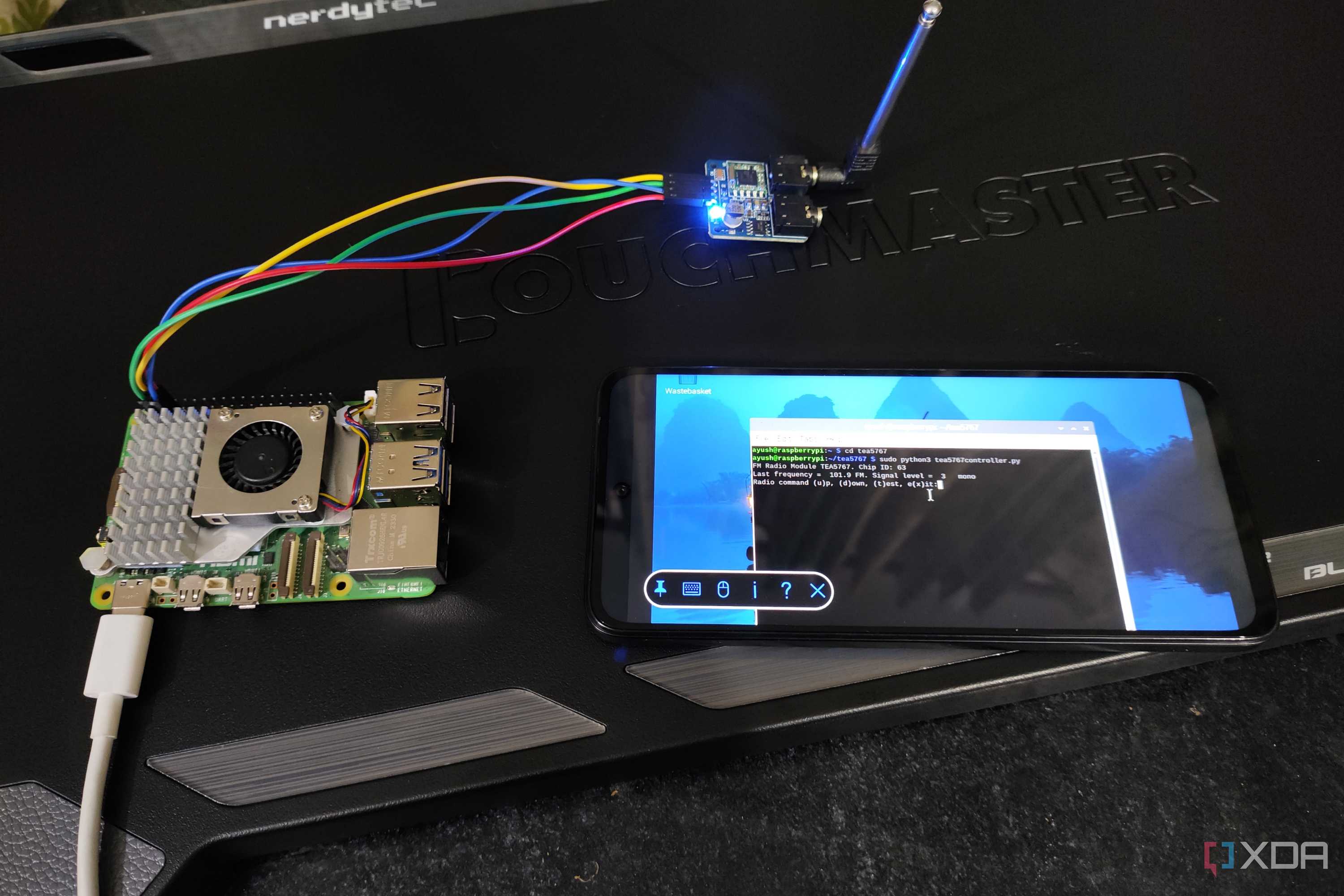 A Raspberry Pi 5 connected to a TEA5767 radio module and a Poco M6 Pro running the FM radio inside the terminal