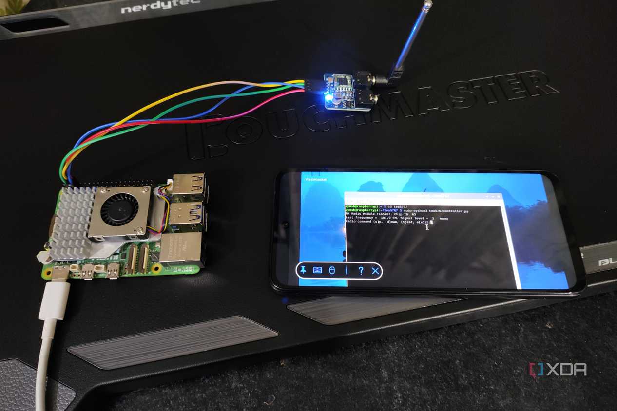 A Raspberry Pi 5 connected to a TEA5767 radio module and a Poco M6 Pro running the FM radio inside the terminal