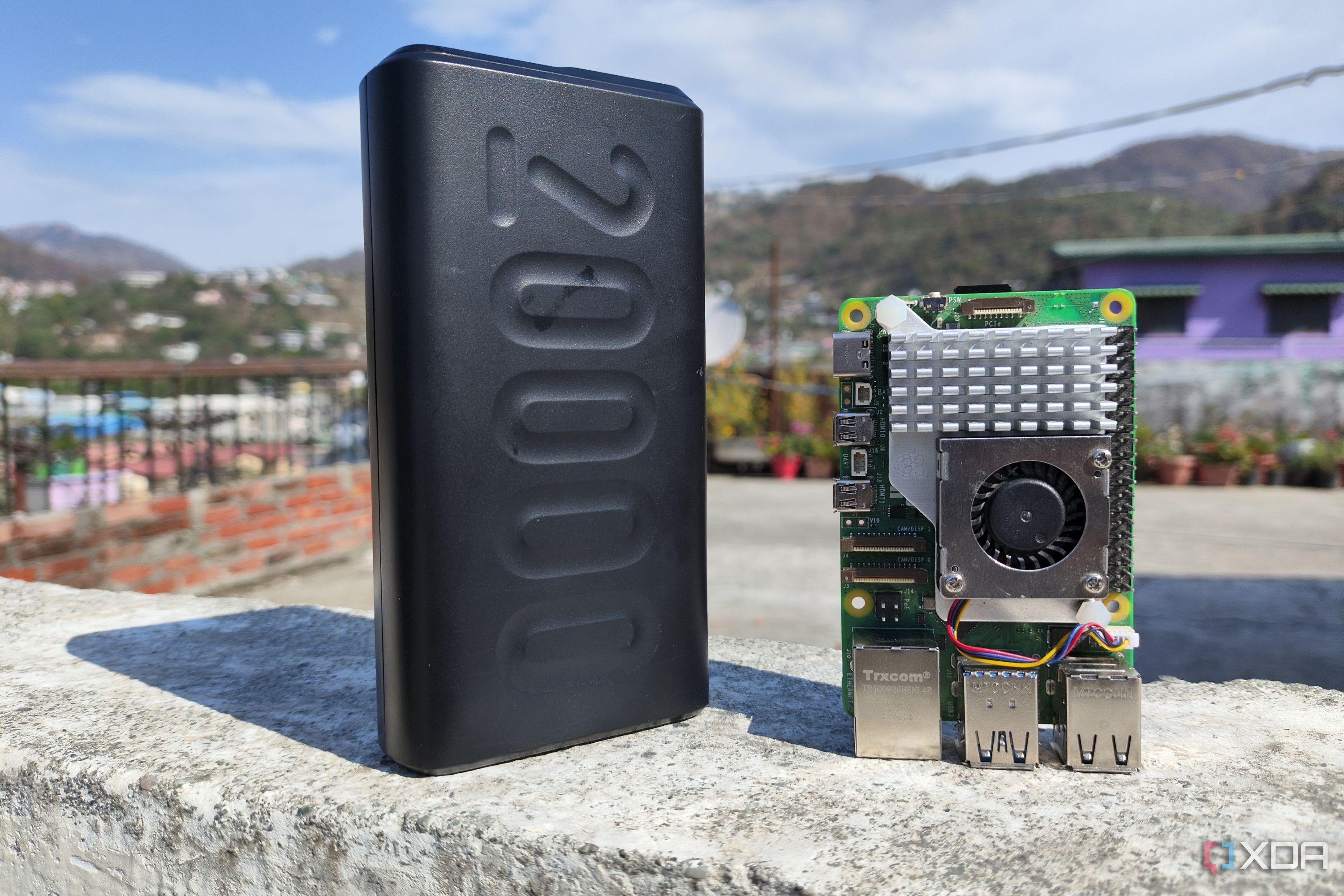 A Raspberry Pi 5 with a power bank placed near it