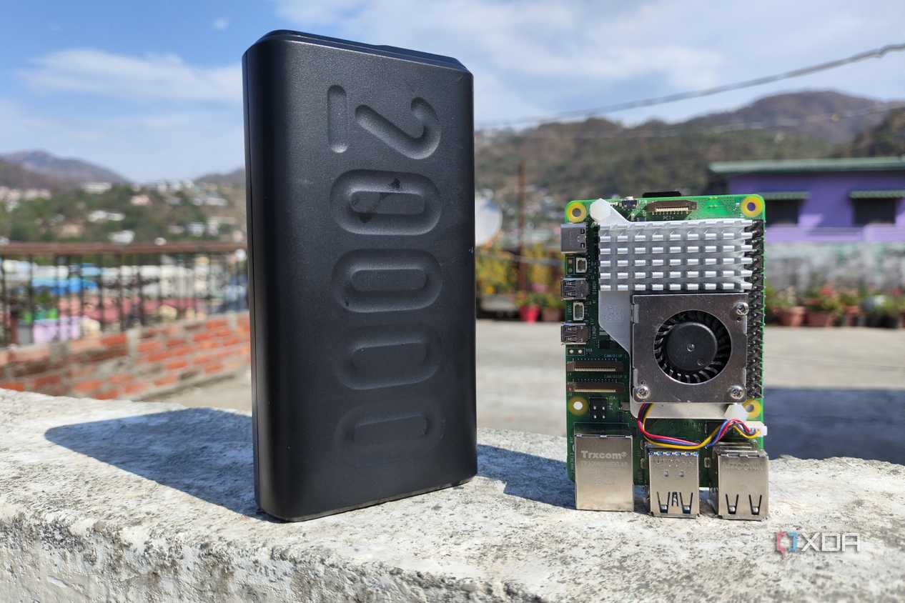 A Raspberry Pi 5 with a power bank placed near it