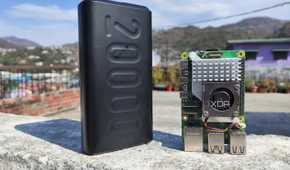 A Raspberry Pi 5 with a power bank placed near it