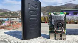 A Raspberry Pi 5 with a power bank placed near it