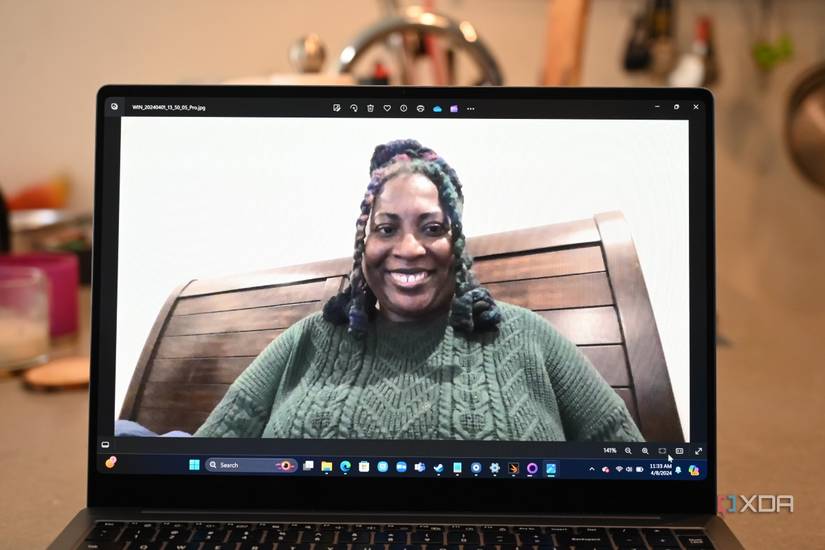 Samsung Galaxy Book 4 Ultra webcam shot of African-American woman wearing green sweater