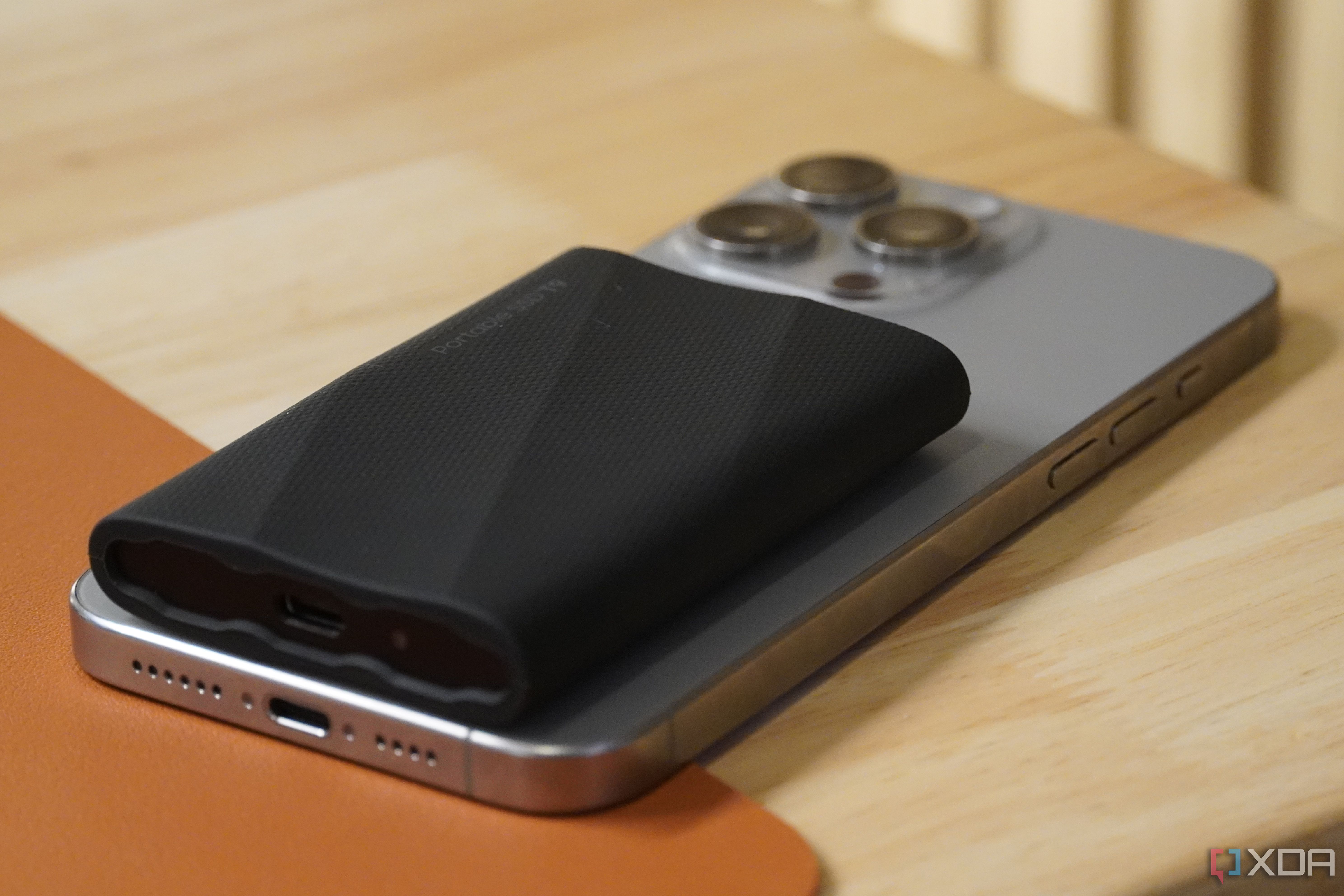 A side view of a Samsung SSD on top of an iPhone.